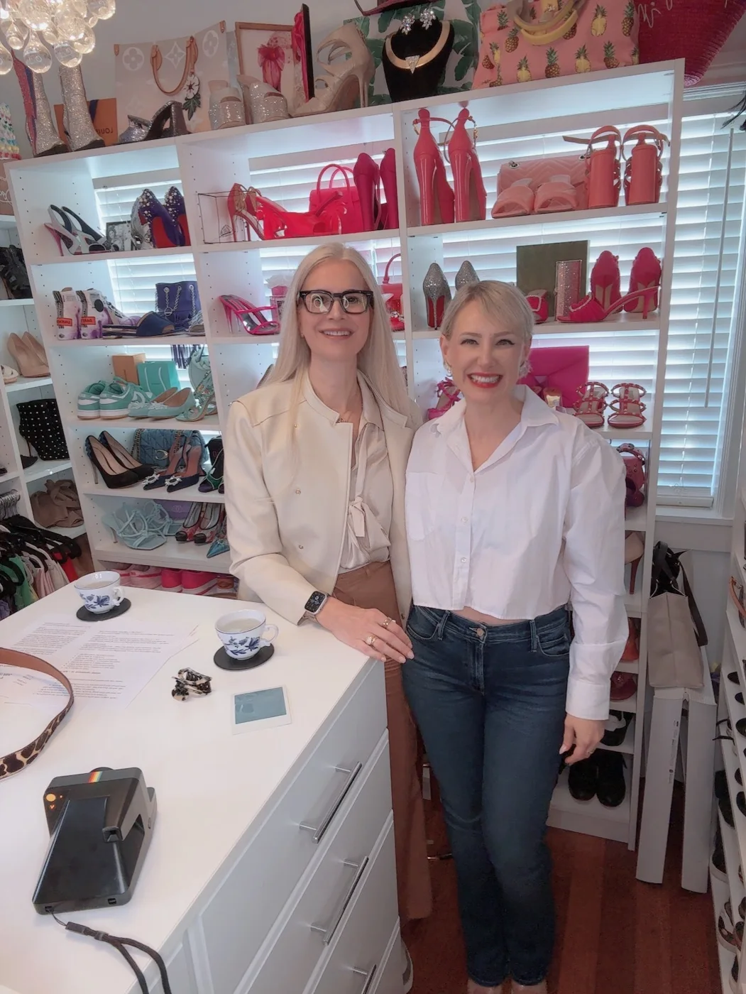 Dr. Silvia Rotemberg with Anna Anisin in a closet lined with colorful heels and handbags