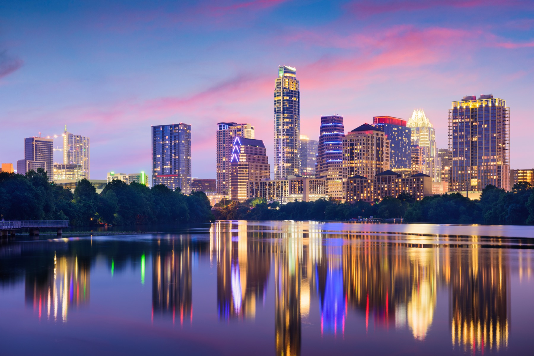 Austin skyline at dusk reflected on the water.