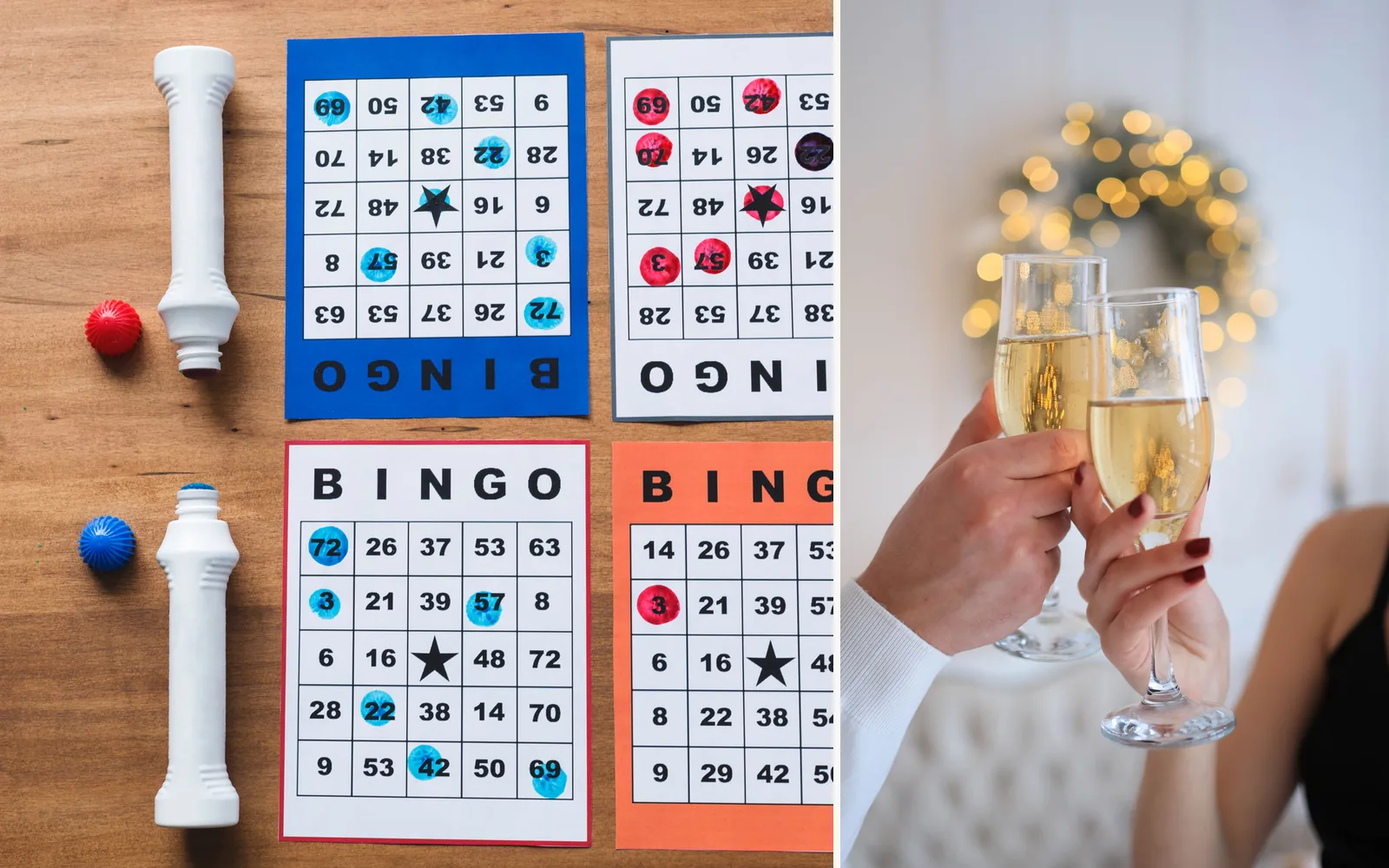 Bingo cards with blue and red dabbers on a wooden table beside two hands raising glasses of sparkling wine in a toast